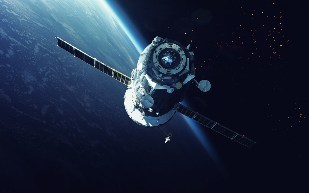 satellite flying in space with the Earth in the background