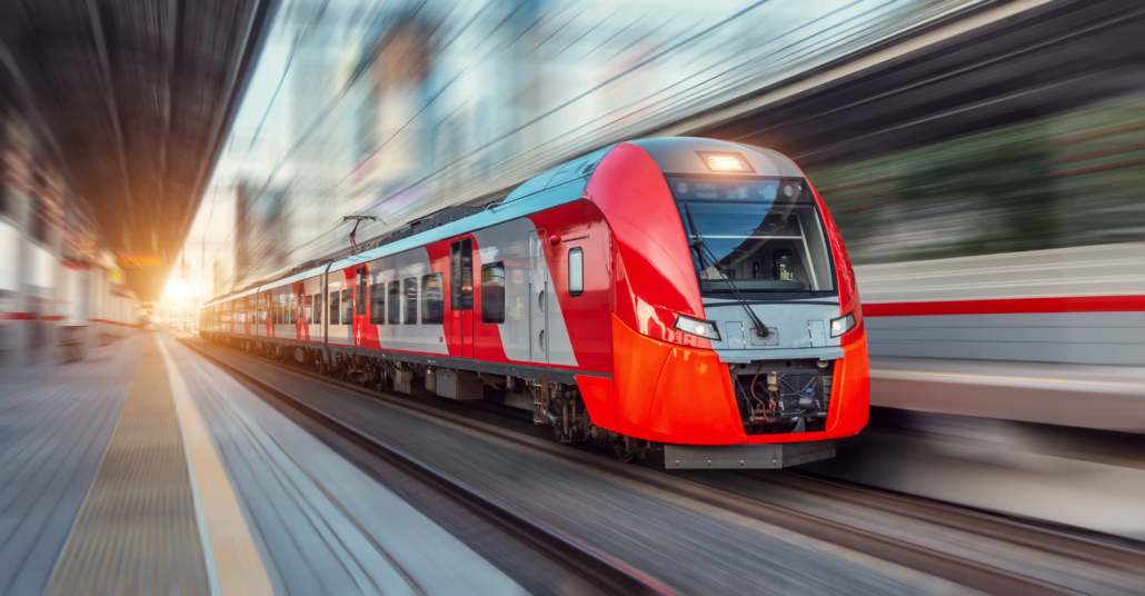 A red train going by, with motion blur lines emphasizing its high speed