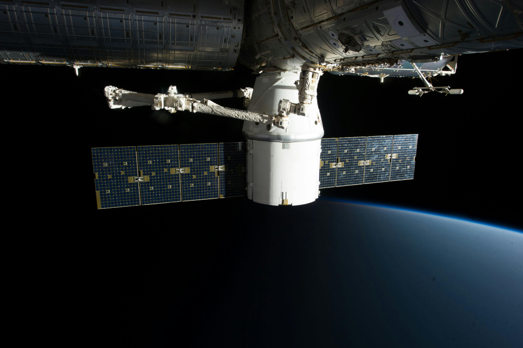 A satellite flying in space against a dark background